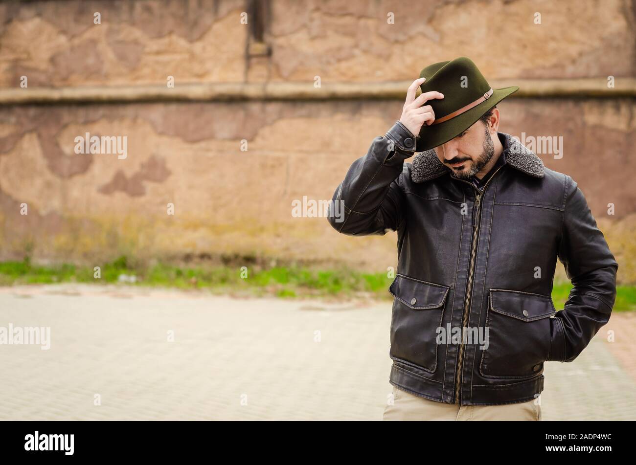 man with jacket and hat in the street Stock Photo
