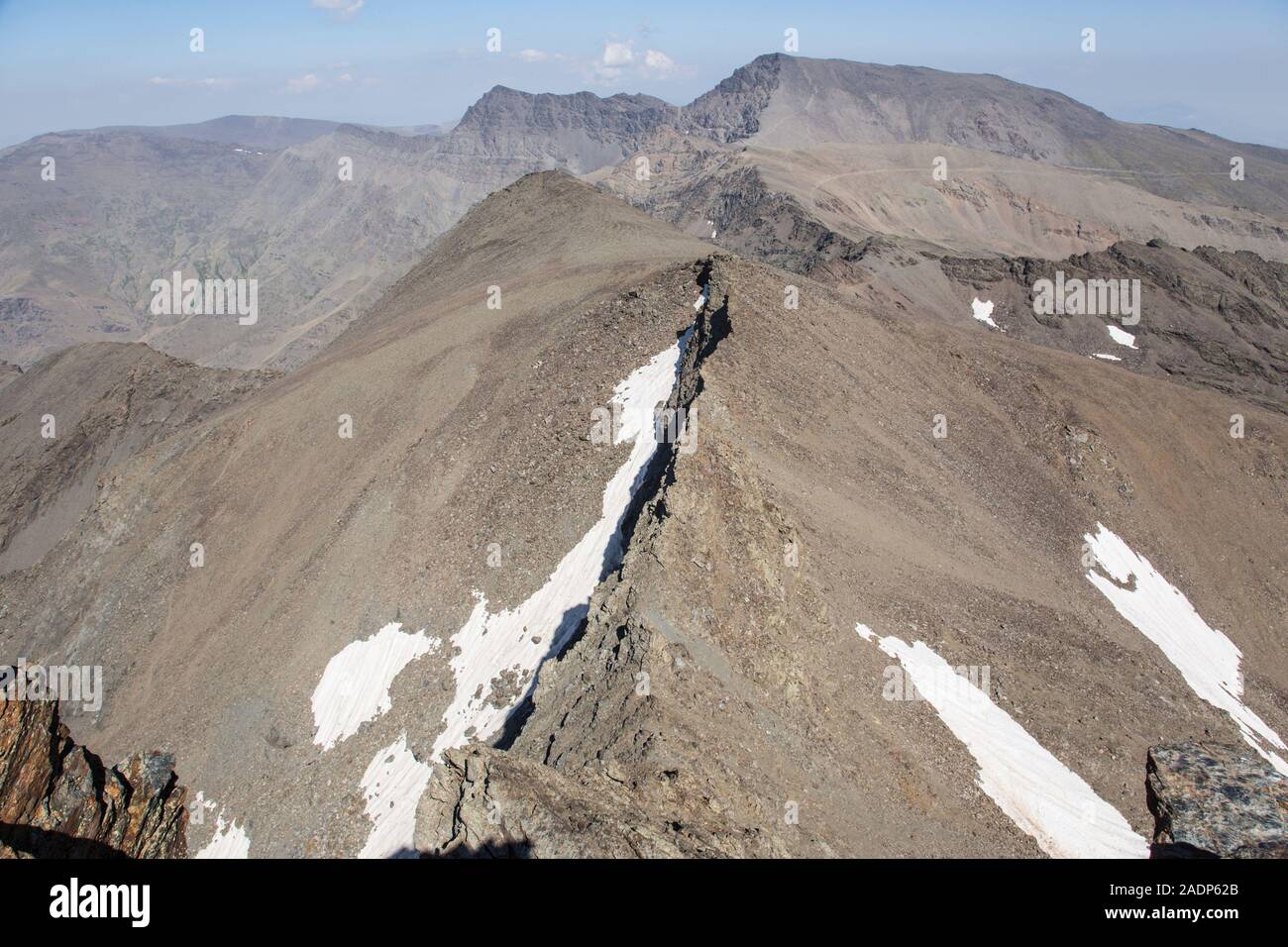 The highest peaks of the Sierra Nevada mountain range, viewed from the summit of Pico Veleta in summer, Andalusia, Spain Stock Photo