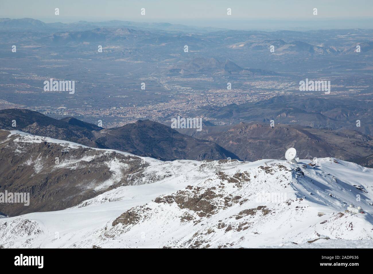 The IRAM radio astronomy telespcope in the Sierra Nevada mountains, with Granada city in the distance below. Andalusia, Spain Stock Photo