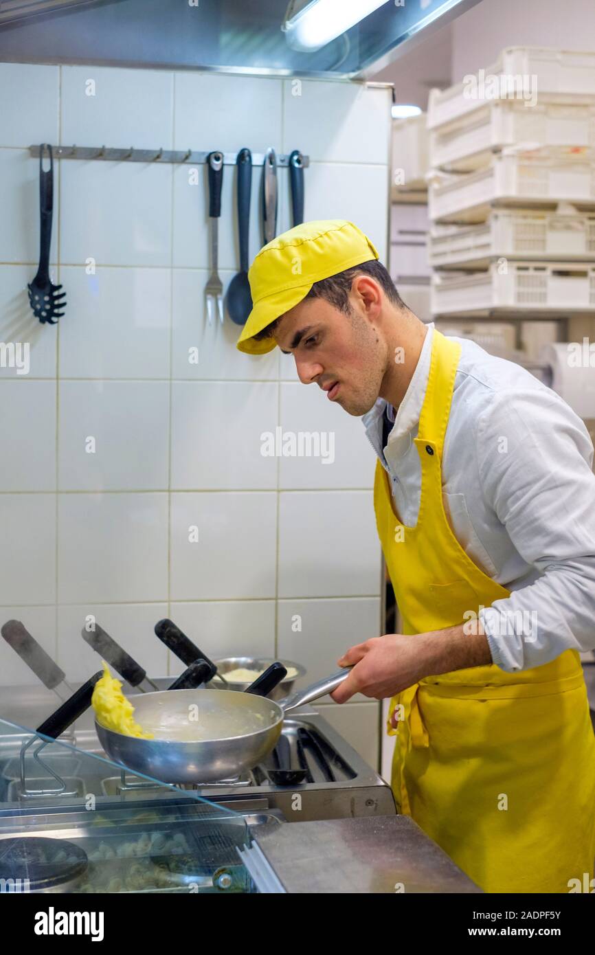 Man preparing fresh pasta at Mercato di San Lorenzo, Florence (Firenze), Tuscany, Italy, Europe. Stock Photo