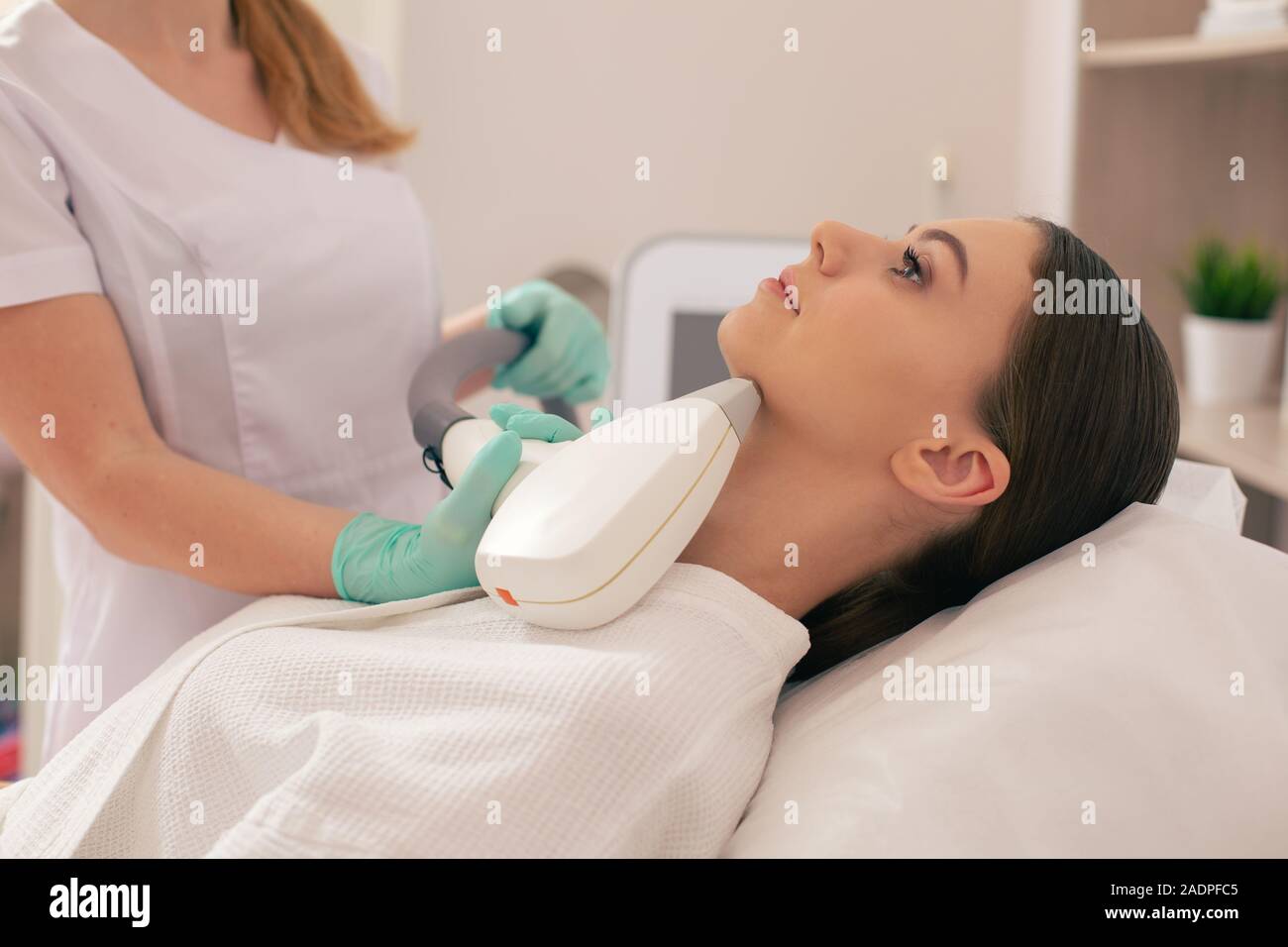 Confident woman undergoing new laser hair removal procedure Stock Photo