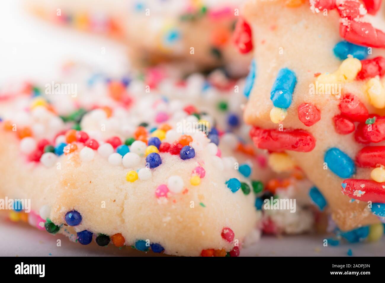 Sugar Cookie covered in rainbow sprinkles closeup Stock Photo Alamy
