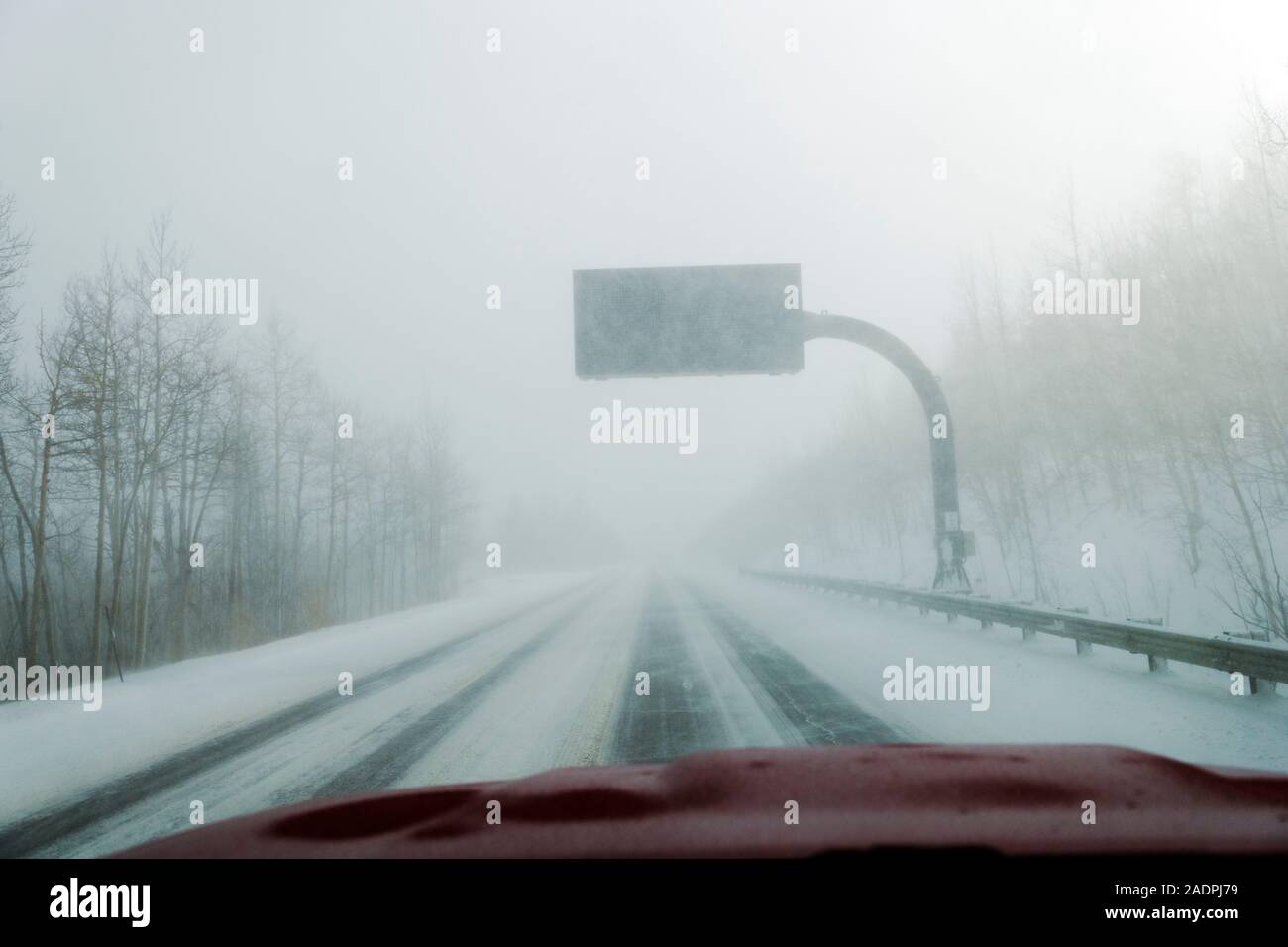 Windshield view of hazardous snow blizzard on highway 285; Park County; Colorado; USA Stock Photo