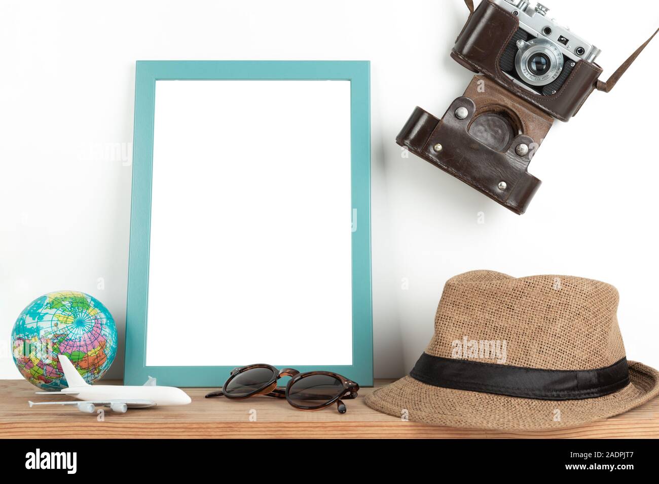 Interior poster mock up with vertical wooden frame, travel theme, on white wall background Stock Photo