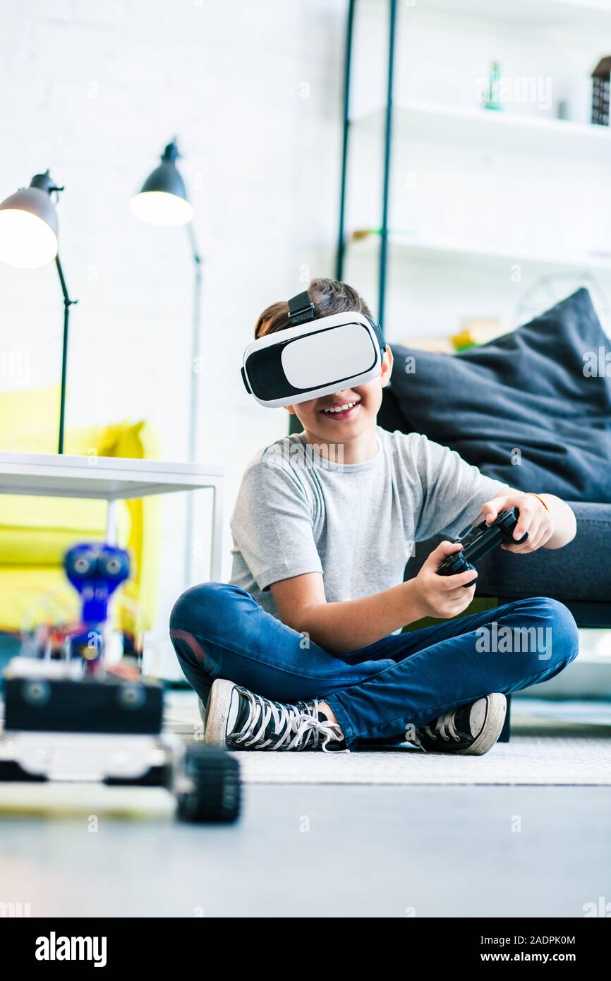 Positive little boy using modern technologies at home Stock Photo - Alamy