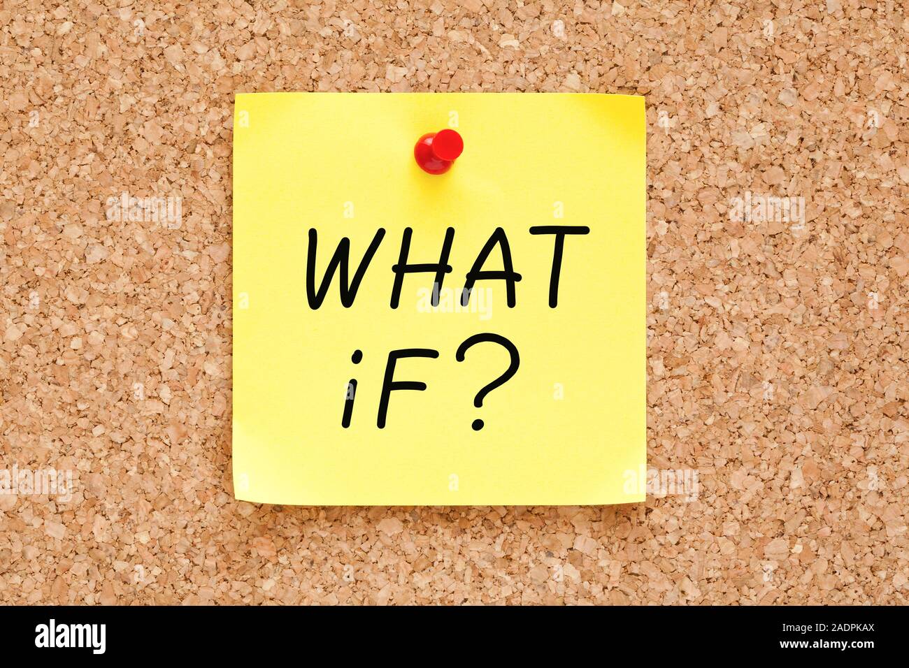 Question What If? handwritten on yellow sticky note pinned on cork bulletin board. Stock Photo