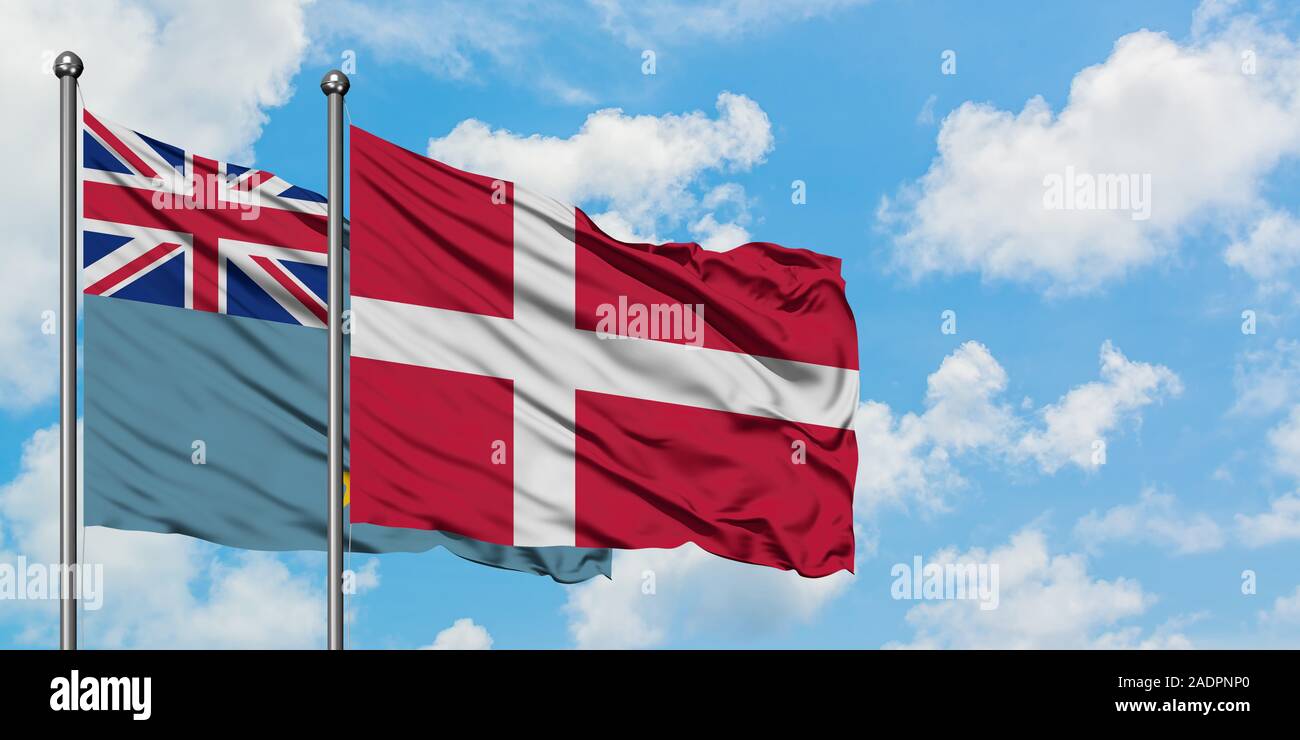 Tuvalu and Denmark flag waving in the wind against white cloudy blue sky together. Diplomacy concept, international relations. Stock Photo