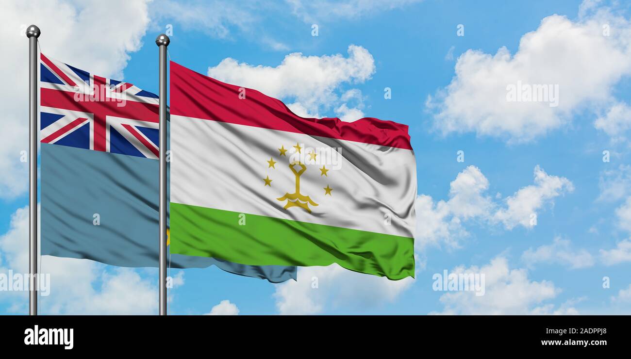 Tuvalu and Tajikistan flag waving in the wind against white cloudy blue sky together. Diplomacy concept, international relations. Stock Photo