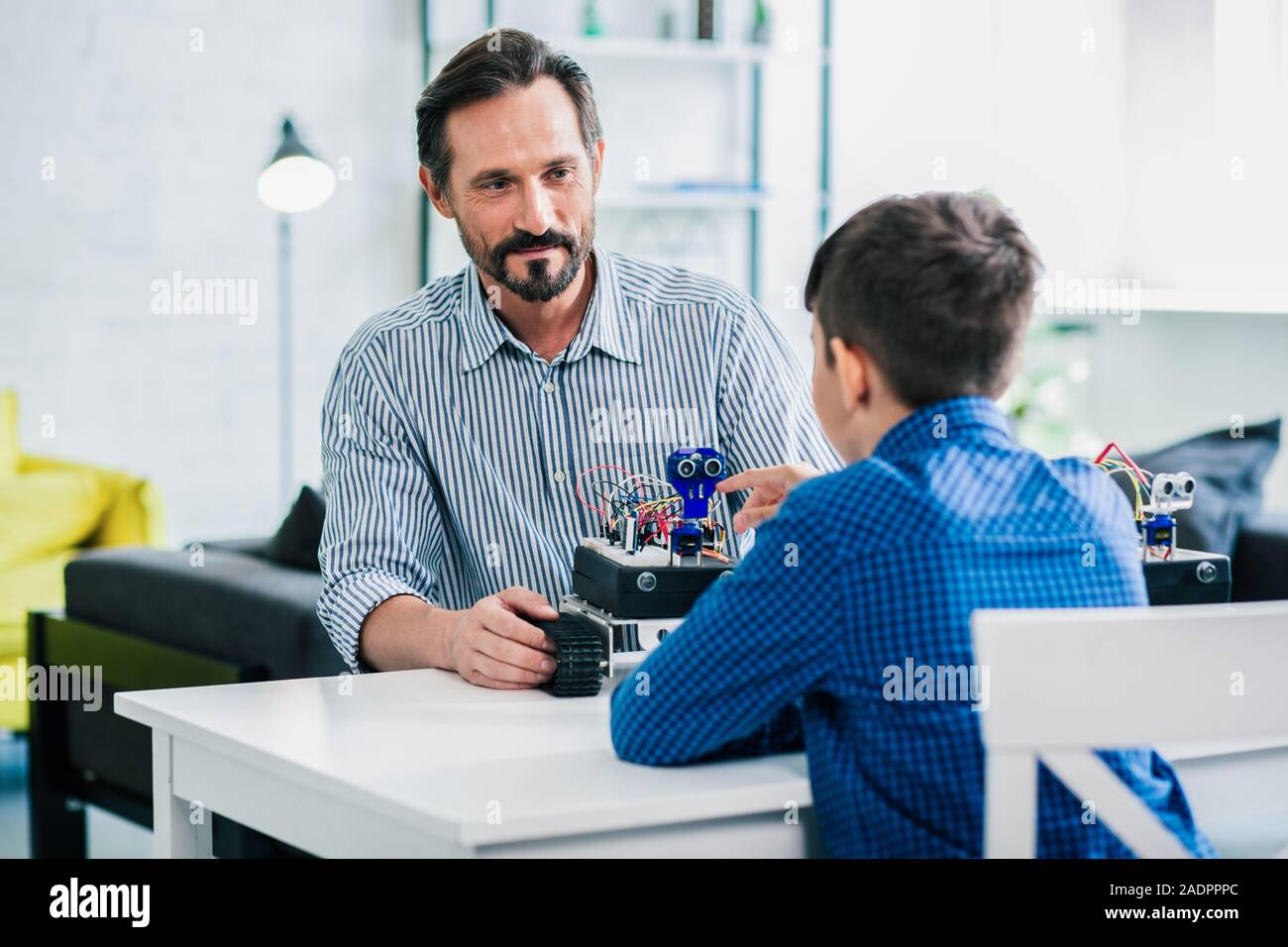 Software Engineer Father Pleasant helpful father enjoying robotic engineering with his son Stock ...