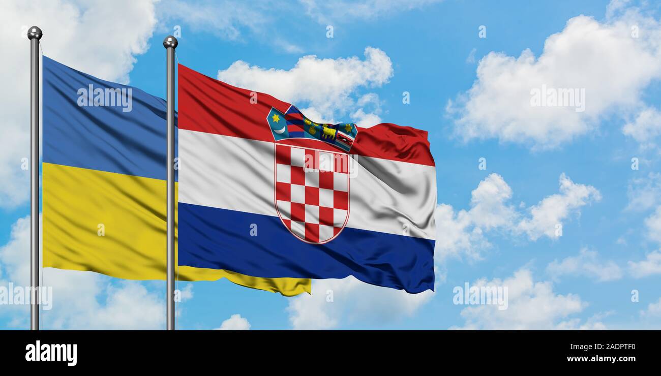 Ukraine and Croatia flag waving in the wind against white cloudy blue sky together. Diplomacy concept, international relations. Stock Photo