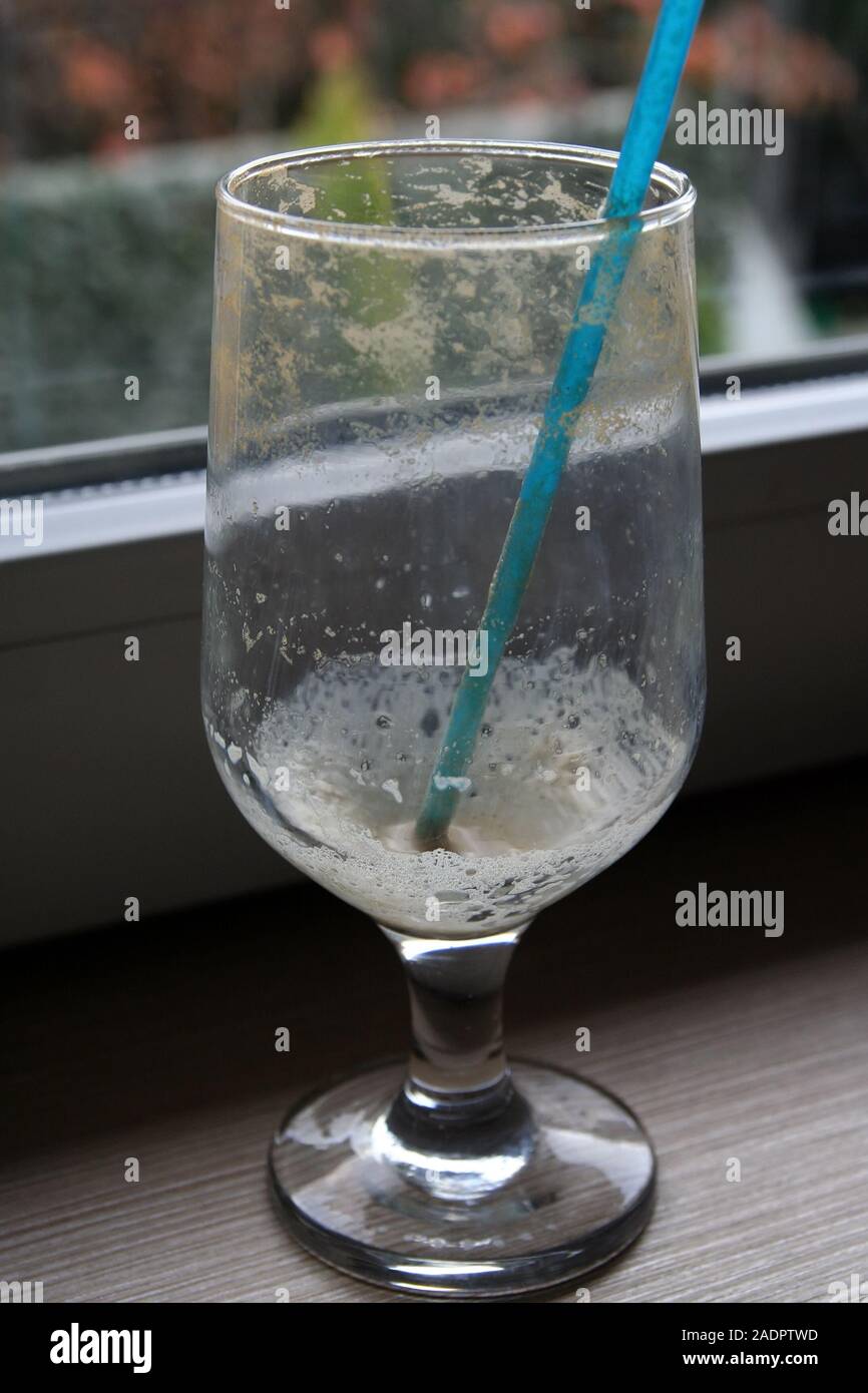 Empty coffee glass with a straw. Empty ice coffee glass. Stock Photo