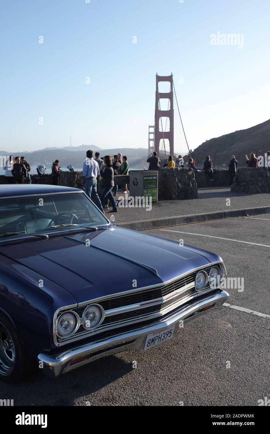 A classic American car parked in front of the Golden Gate Bridge in San ...