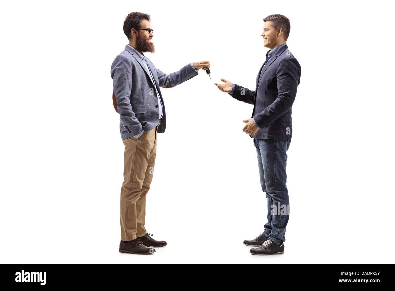 Full length profile shot of a bearded man giving car keys to a young man isolated on white background Stock Photo