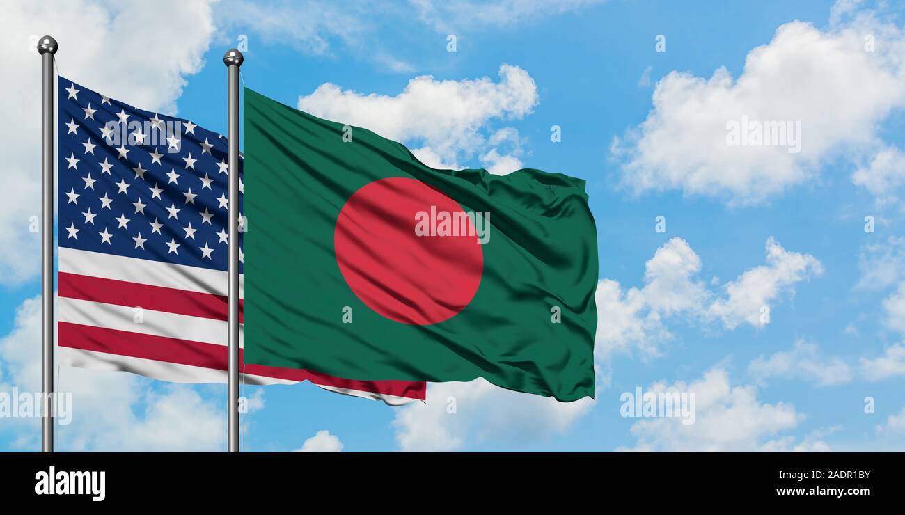 United States and Bangladesh flag waving in the wind against white cloudy blue sky together. Diplomacy concept, international relations. Stock Photo