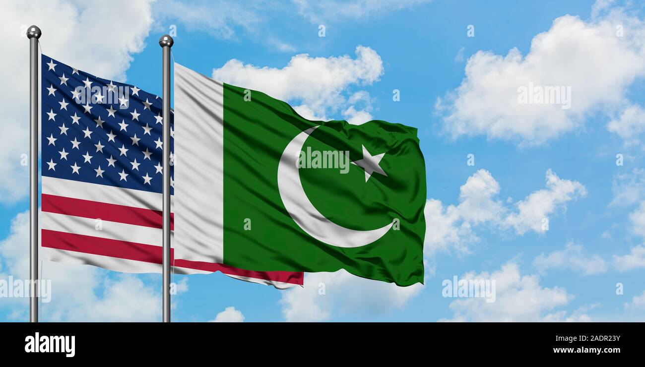 United States and Pakistan flag waving in the wind against white cloudy blue sky together. Diplomacy concept, international relations. Stock Photo