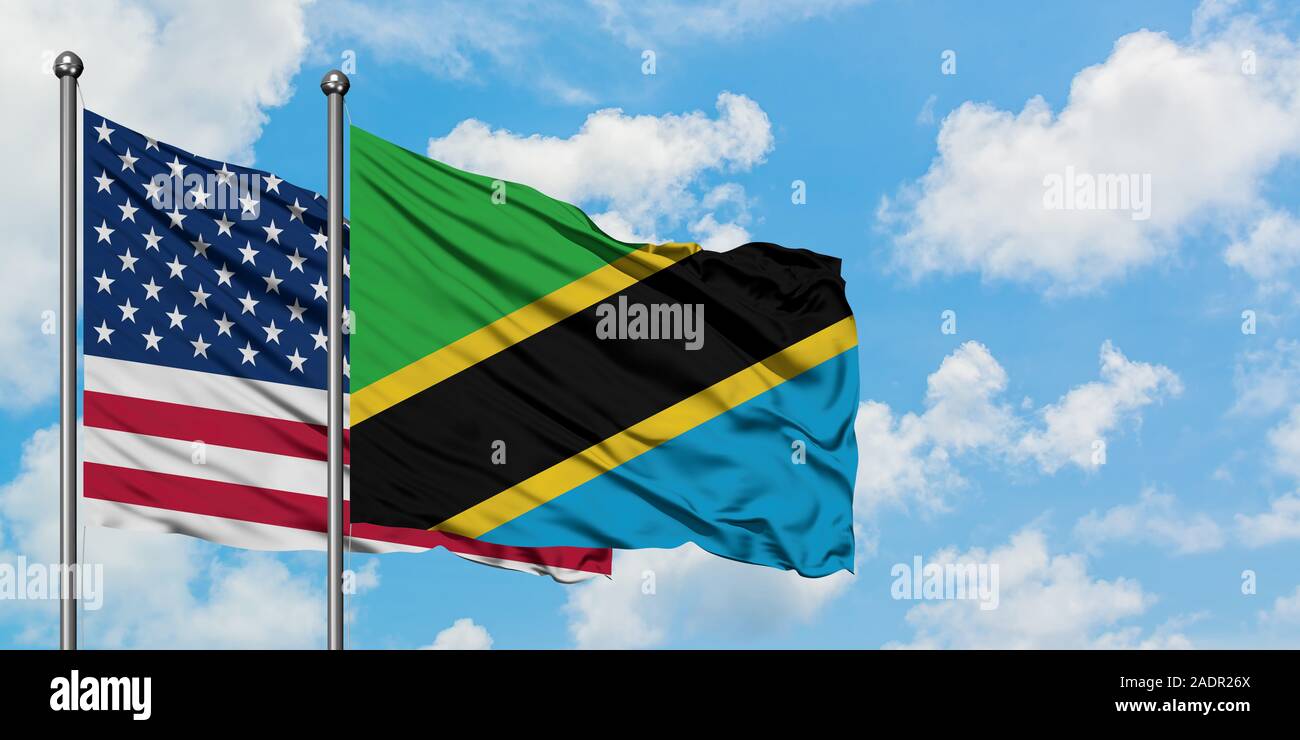 United States and Tanzania flag waving in the wind against white cloudy ...
