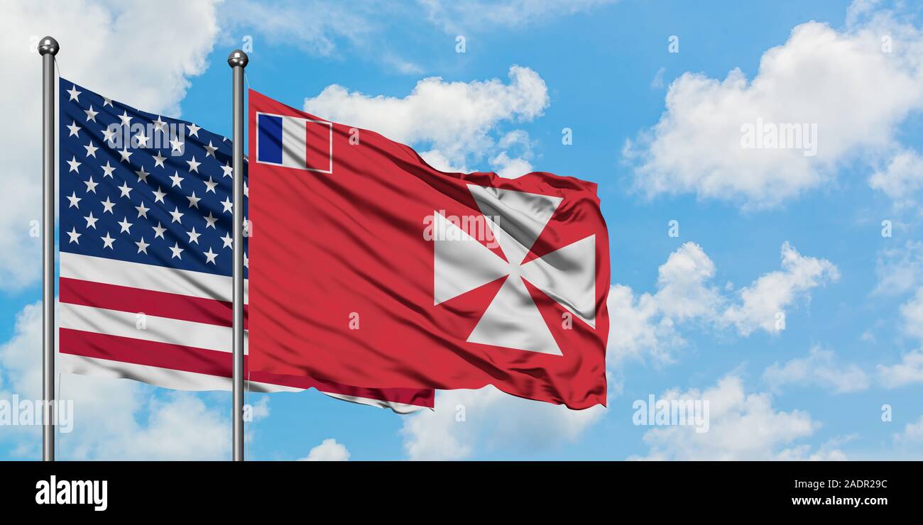 United States and Wallis And Futuna flag waving in the wind against white cloudy blue sky together. Diplomacy concept, international relations. Stock Photo