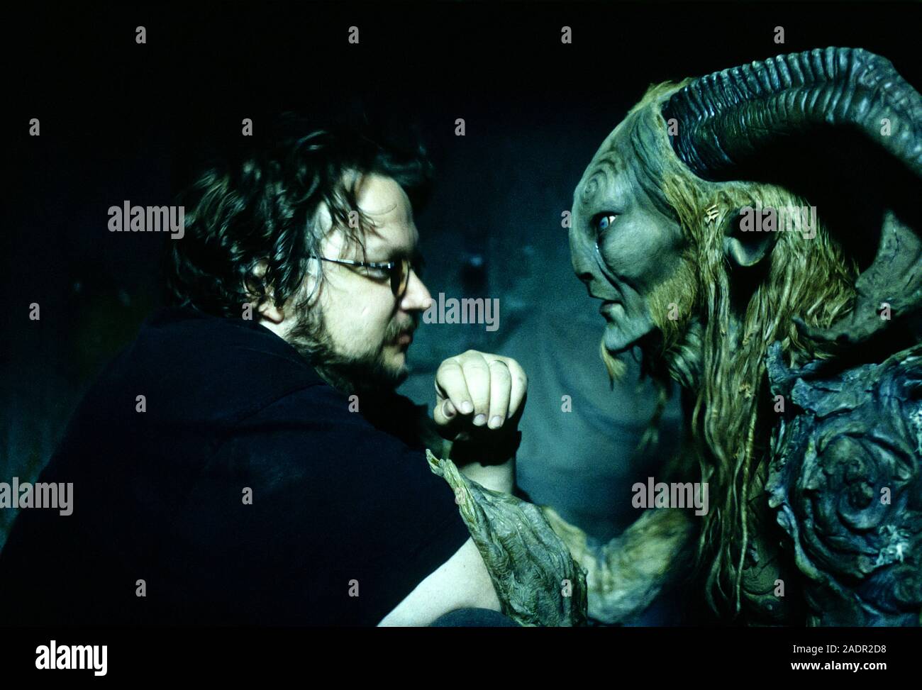 Guillermo del Toro on set with Doug Jones as the Faun in full makeup during the making of Pan's Labyrinth (2006) about a young girl living in Falangist Spain about a girl escapes the horror around her by entering in to a strange fantasy world. Stock Photo