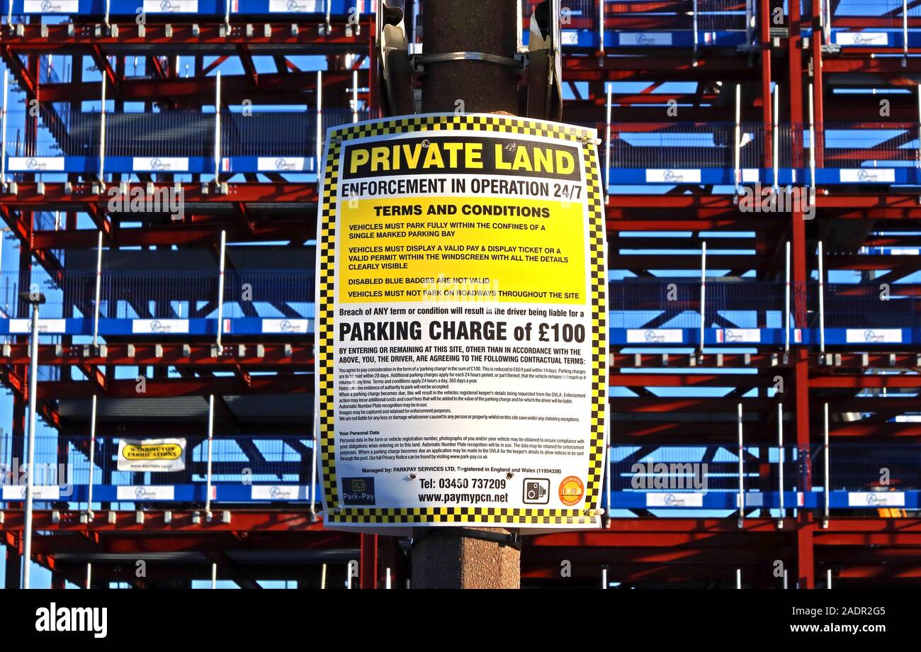 Private land,Enforcement in operation,24/7,Terms and Conditions,Parking Charge of £100,Winwick Road,Warrington,Cheshire,England,UK Stock Photo