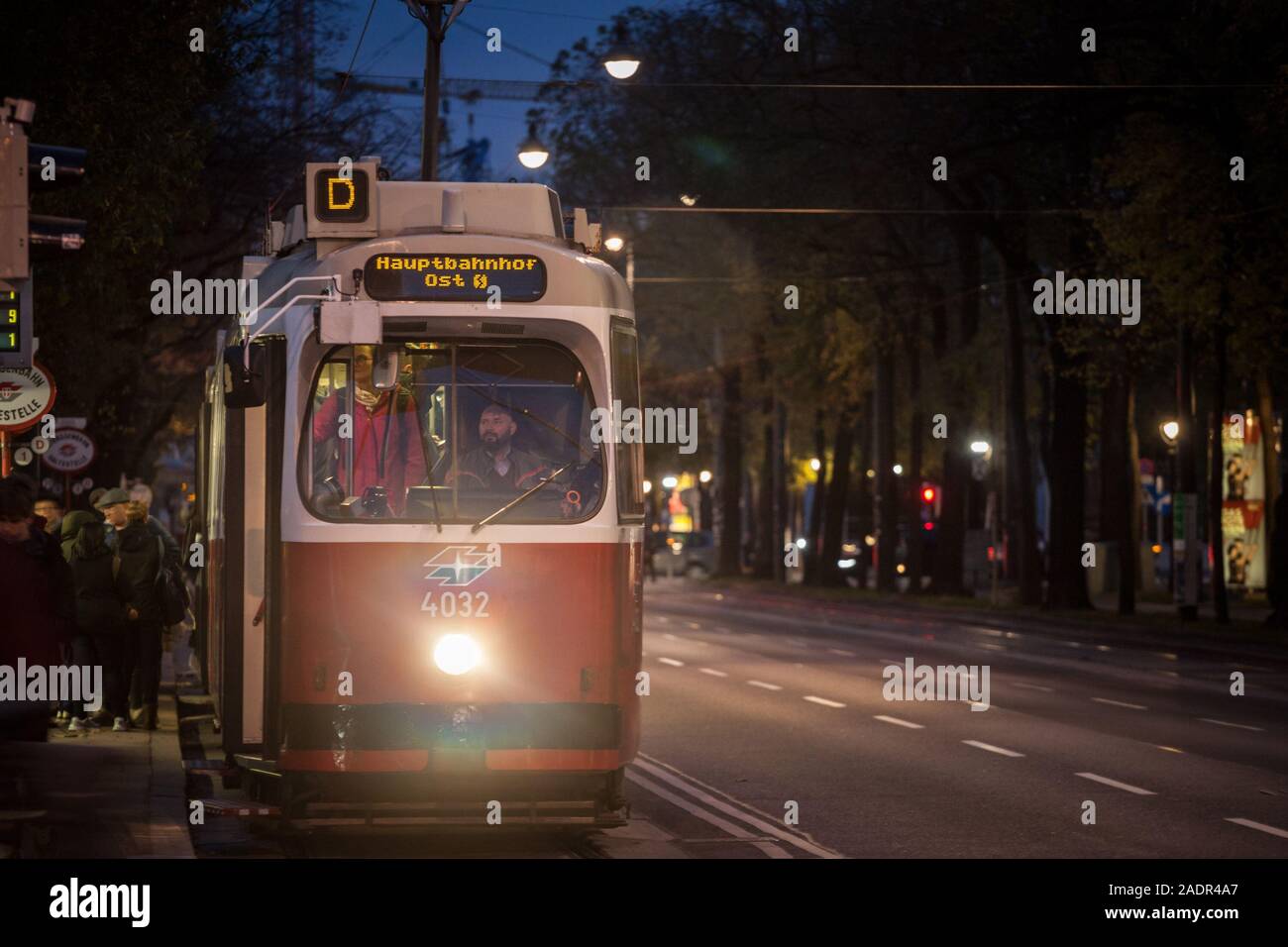 VIENNA, AUSTRIA - NOVEMBER 6, 2019: Vienna tram, also called strassenbahn, leaving a tram station at night in the center of the city. It is one of mai Stock Photo