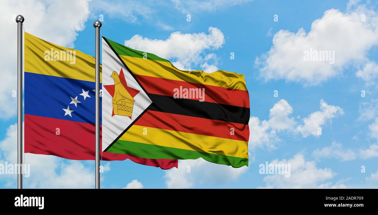 Venezuela and Zimbabwe flag waving in the wind against white cloudy ...