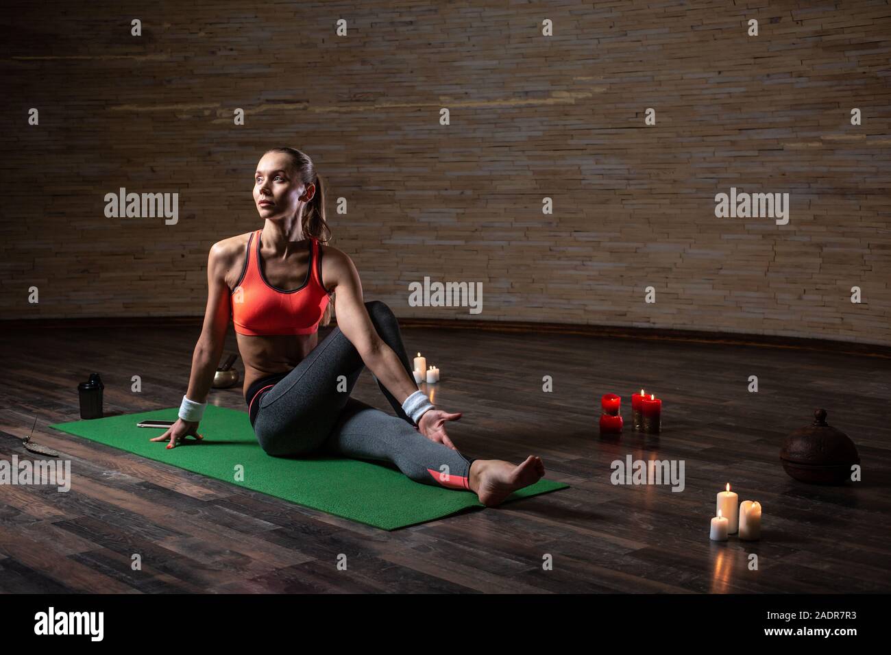 Calm woman looking into the distance while practicing yoga Stock Photo