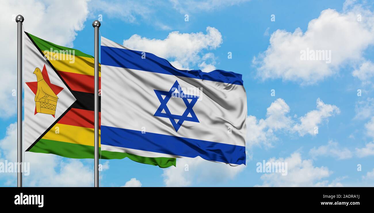 Zimbabwe and Israel flag waving in the wind against white cloudy blue sky together. Diplomacy concept, international relations. Stock Photo
