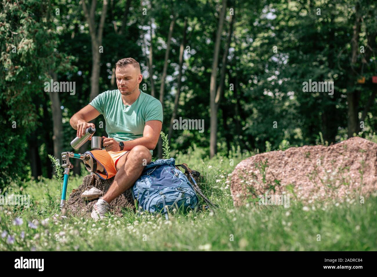 Nice young man with prosthesis resting in harmony with nature Stock Photo