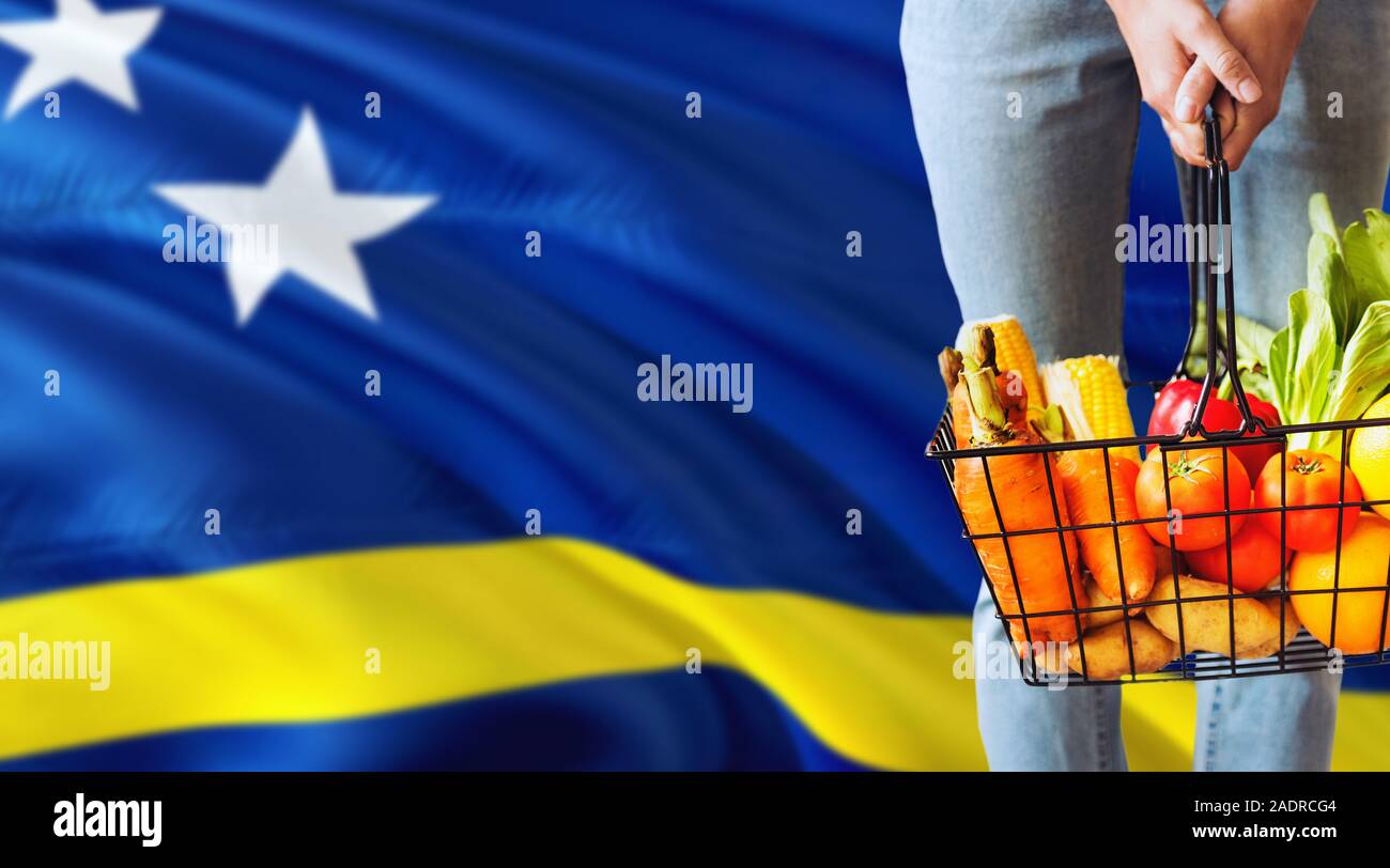 Woman is holding supermarket basket, Cyprus waving flag background