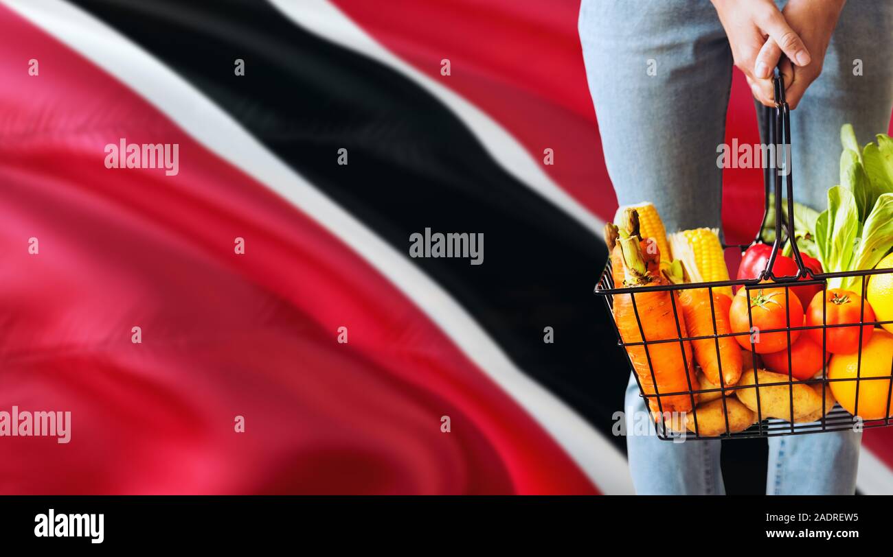 Woman is holding supermarket basket, Trinidad And Tobago waving flag