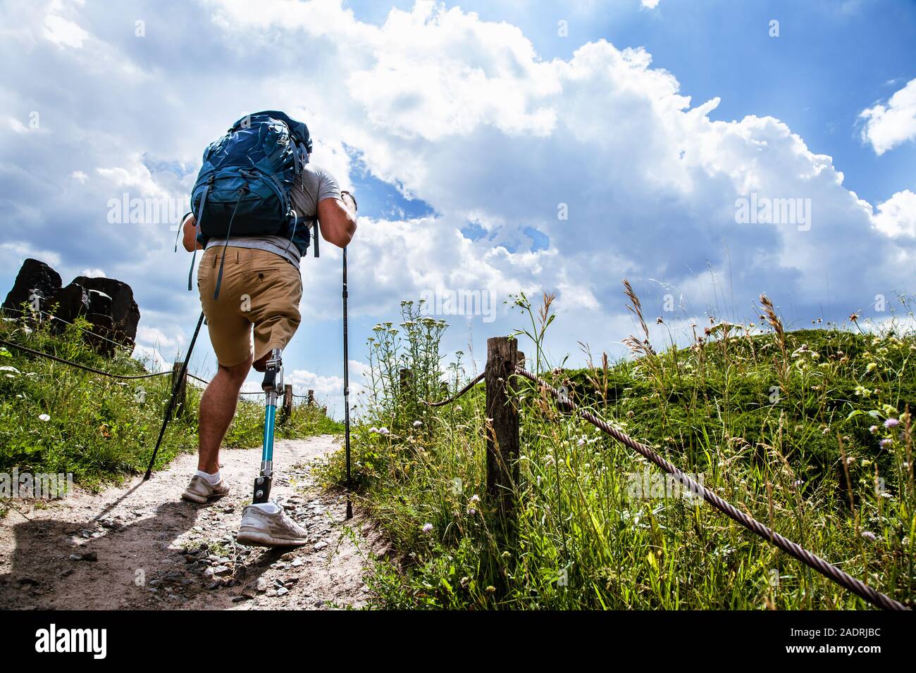 Rear view of a determined disabled man trying Nordic walking Stock Photo