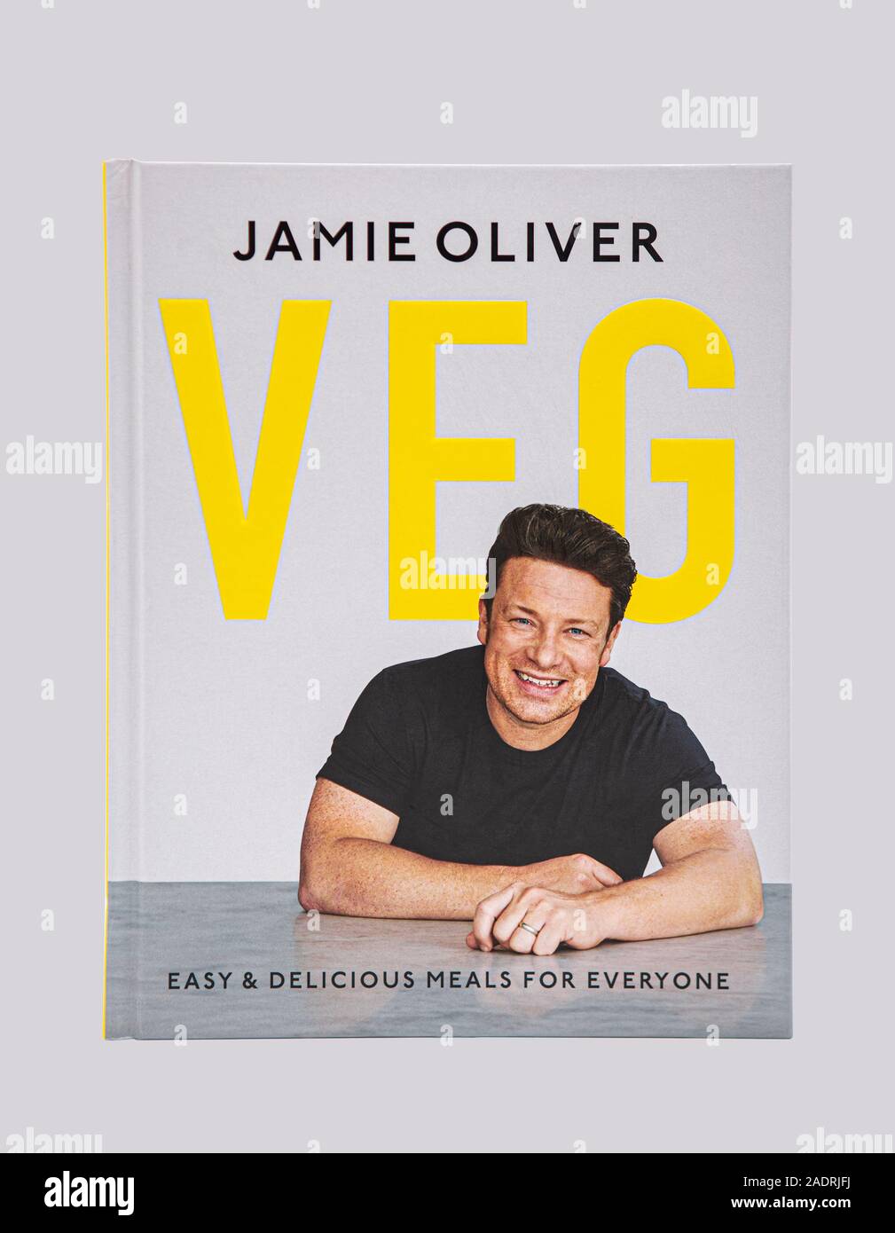 SWINDON, UK - NOVEMBER 25, 2019: Jamie Oliver Veg Cook Book, Easy and Delicious Meals for everyone on a light gray background. Stock Photo