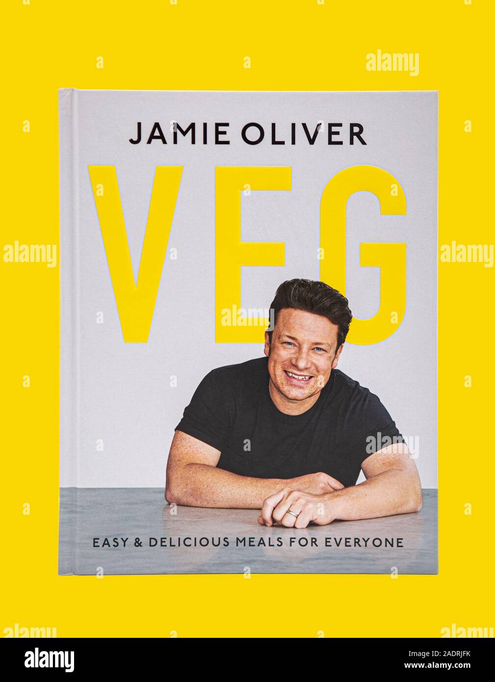SWINDON, UK - NOVEMBER 25, 2019: Jamie Oliver Veg Cook Book, Easy and Delicious Meals for everyone on a yellow background. Stock Photo