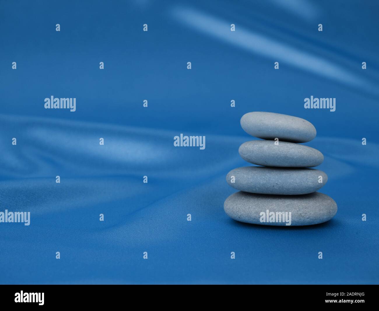 Blue Zen Rocks Stack of Zen stones on abstract blue classic color background of ...