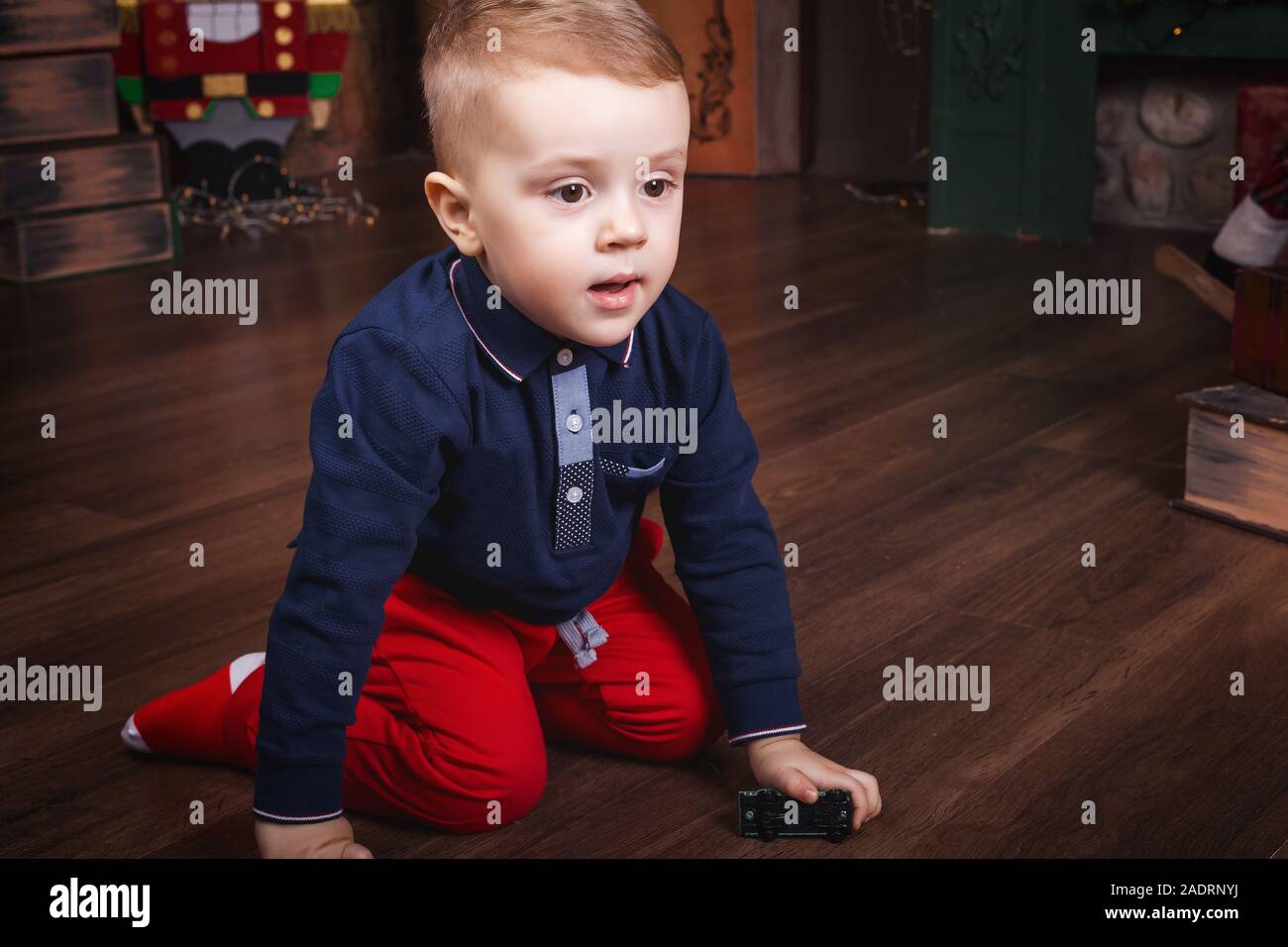 little boy playing toy car sitting on the floor Stock Photo - Alamy