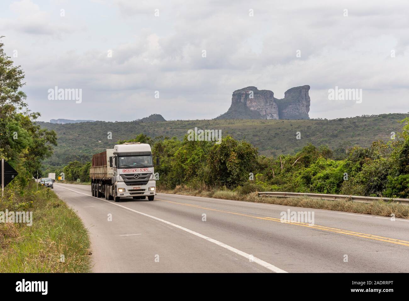 Road trucks passing by express highway with big mountain on the back, Chapada Diamantina, Bahia, Brazil Stock Photo