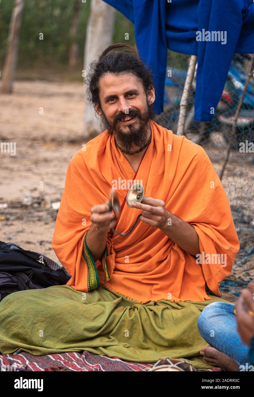 Shantiniketan / India -November 30,2019. An Unidentified Foreigner playing Khanjani musical instrument with Indian  folk singer ( baul) at  khoai mela Stock Photo