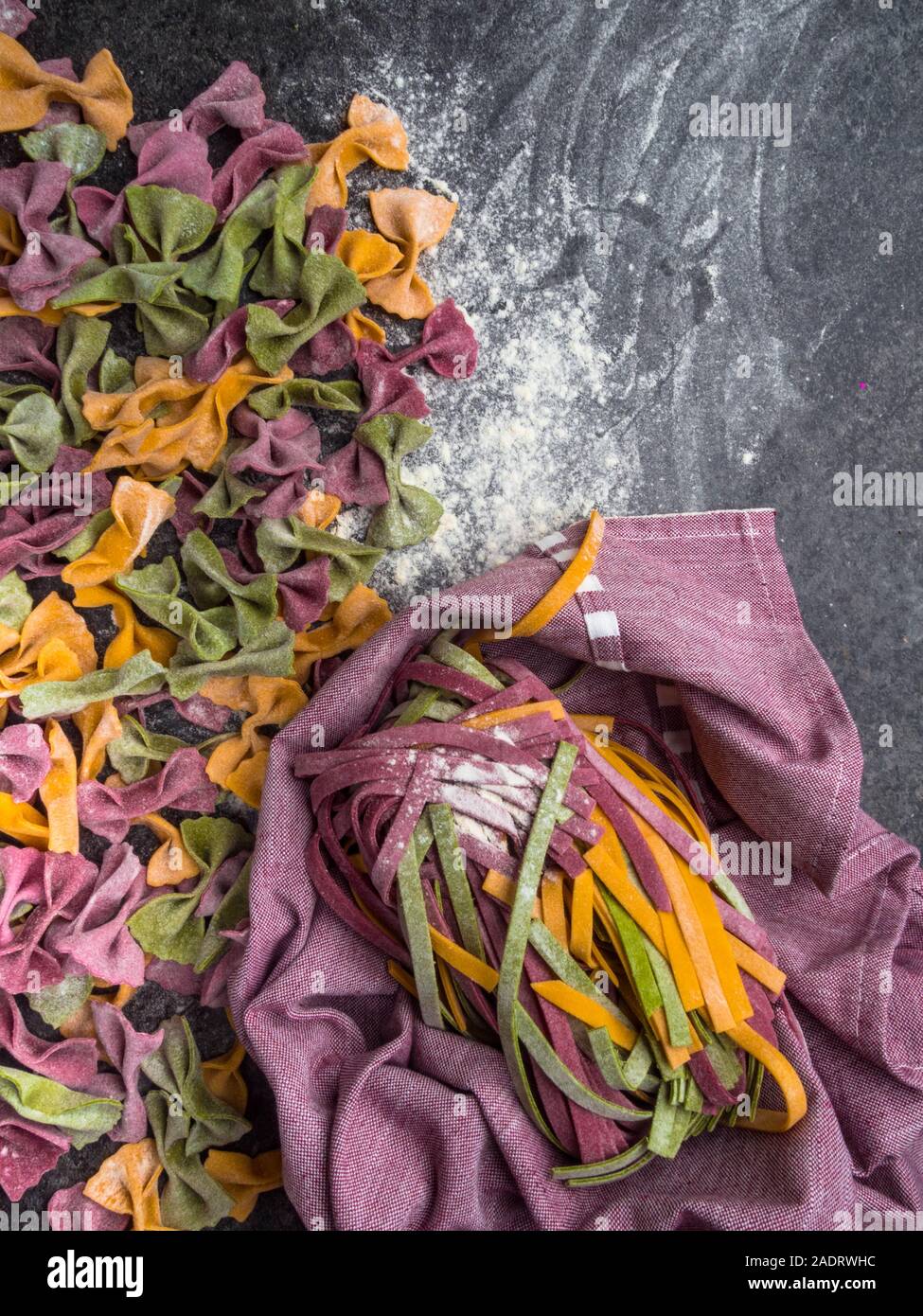 Variety of raw pasta types, farfalle bowtie, fettuccine or tagliatelle