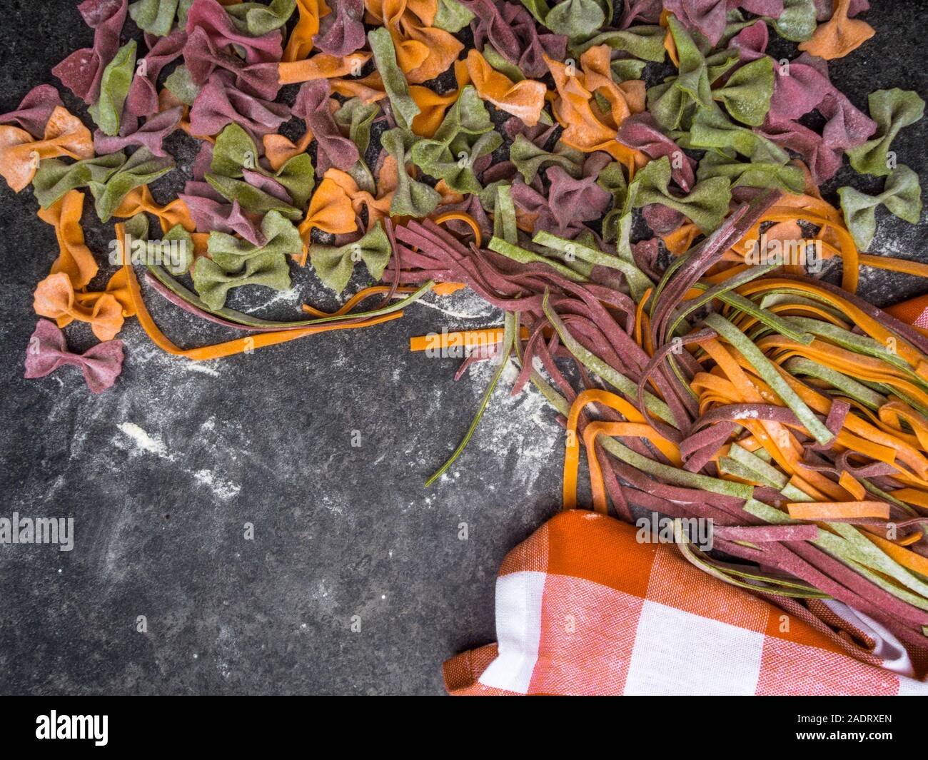 Variety of raw pasta types, farfalle bowtie, fettuccine or tagliatelle