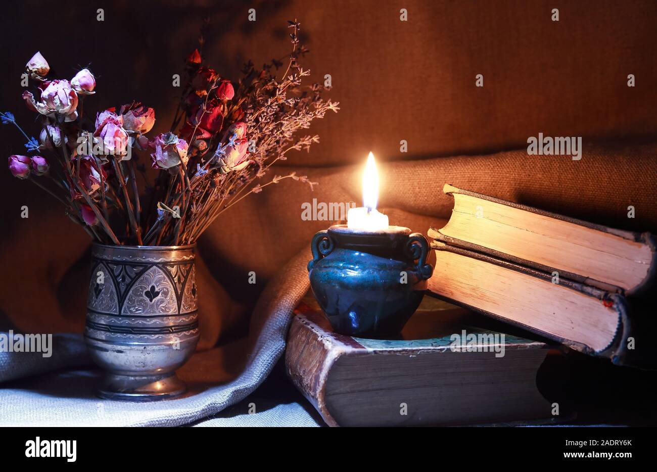 Vintage still life with bouquet of dried flowers in a silver vase near ...