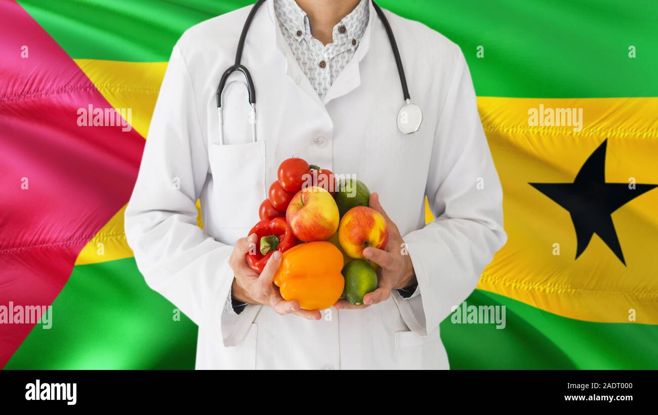 Doctor is holding fruits and vegetables in hands with Sao Tome And