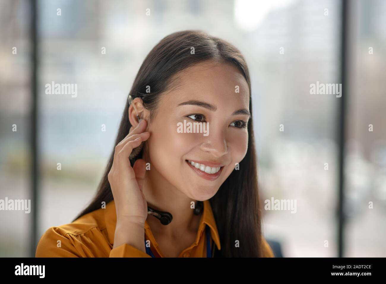 Young pretty asian woman with dark-hair smiling nicely Stock Photo