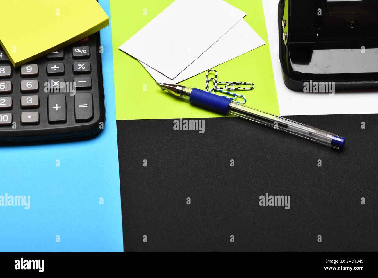 Business and work concept. Calculator and stationery. Hole punch