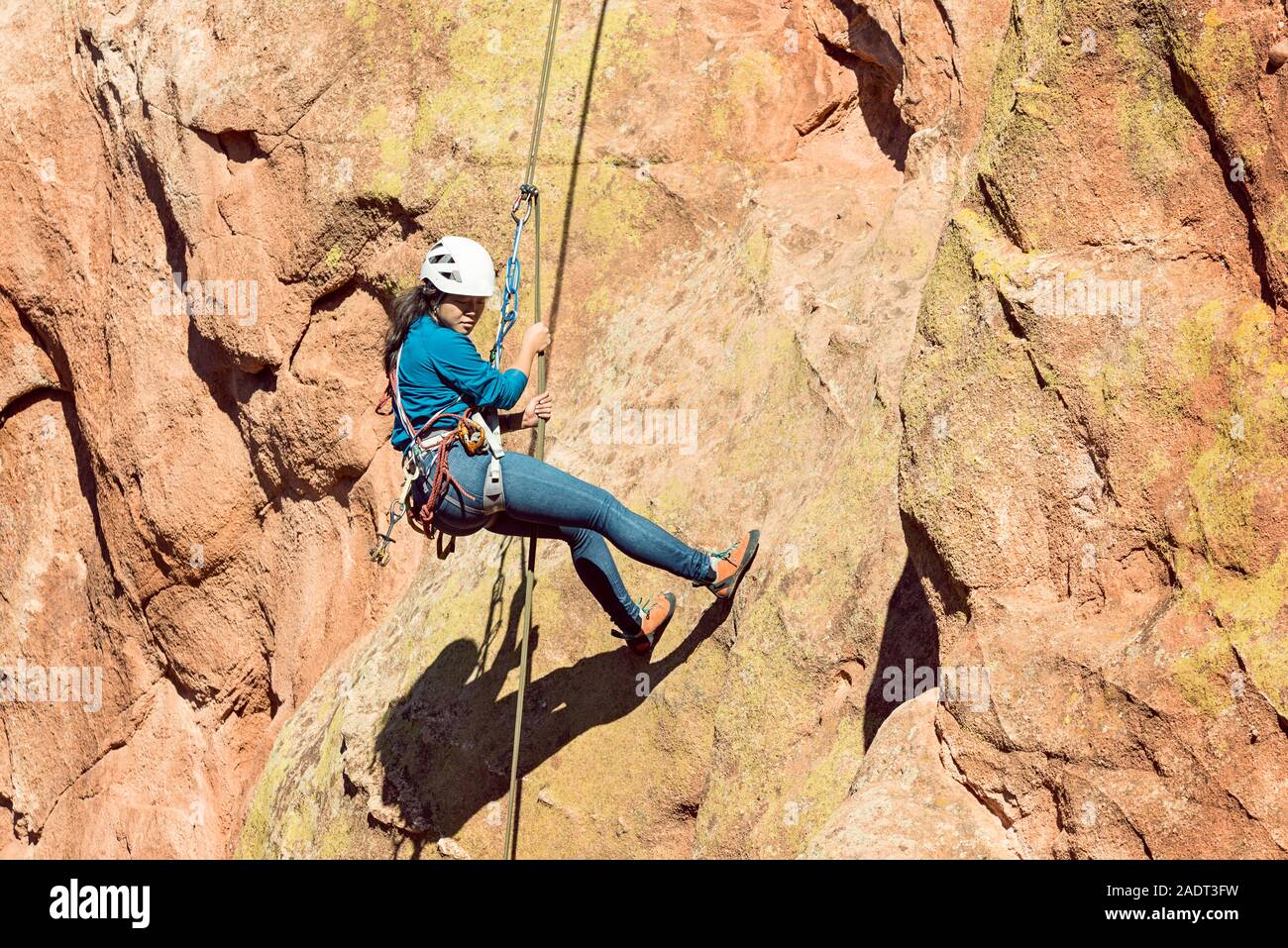 Asian Female Rock Climber at Garden of the Gods Colorado Stock Photo