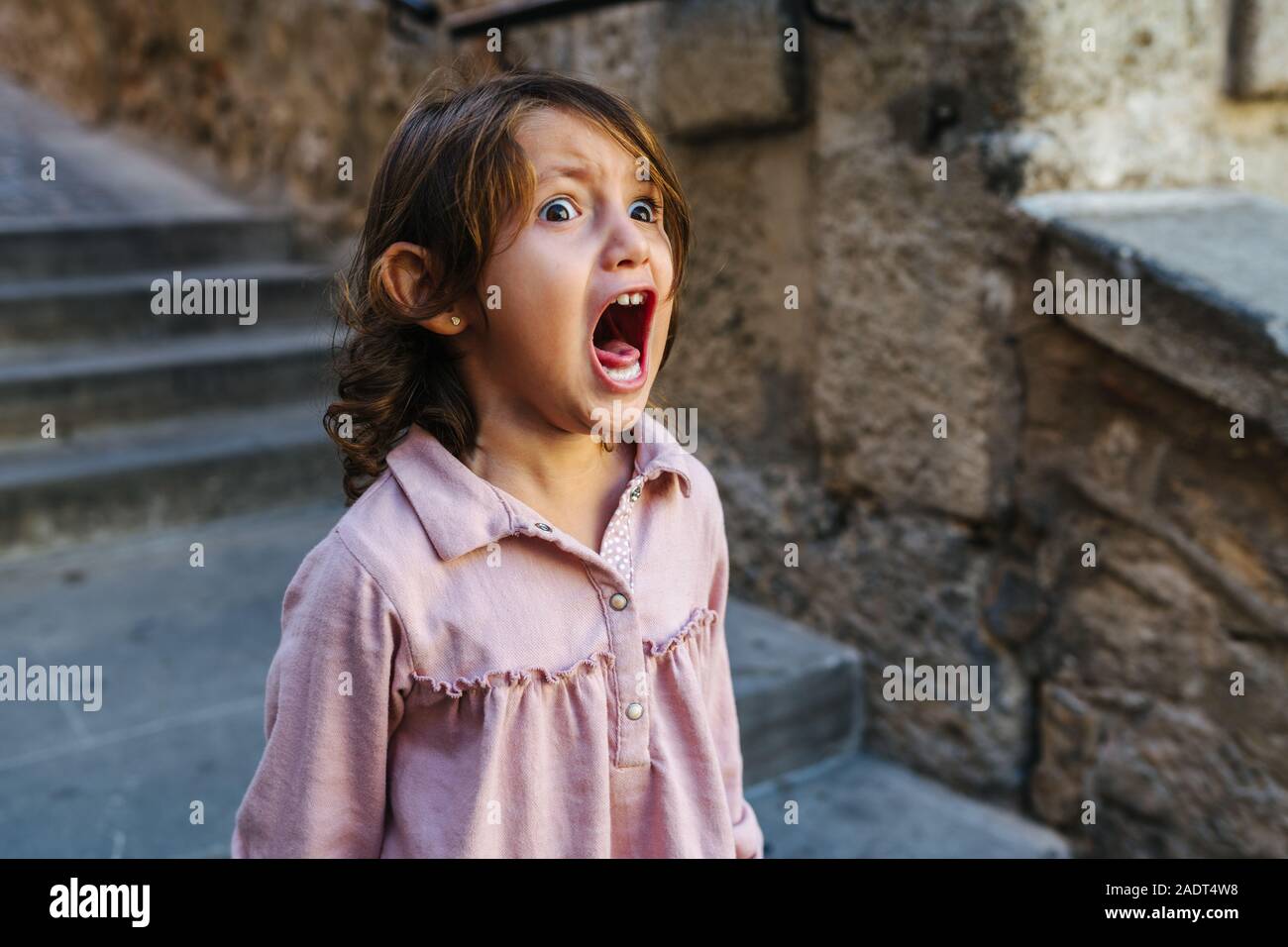 Lovely three year old girl very angry, screaming a sunny day a lot Stock Photo