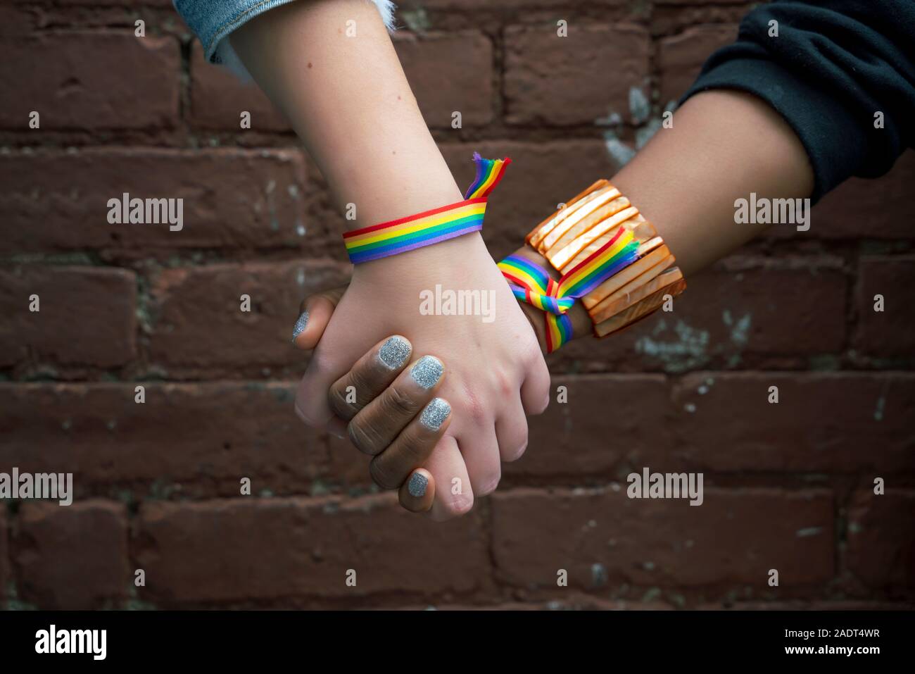 Multiracial gay couple holding hands in Brooklyn Stock Photo - Alamy