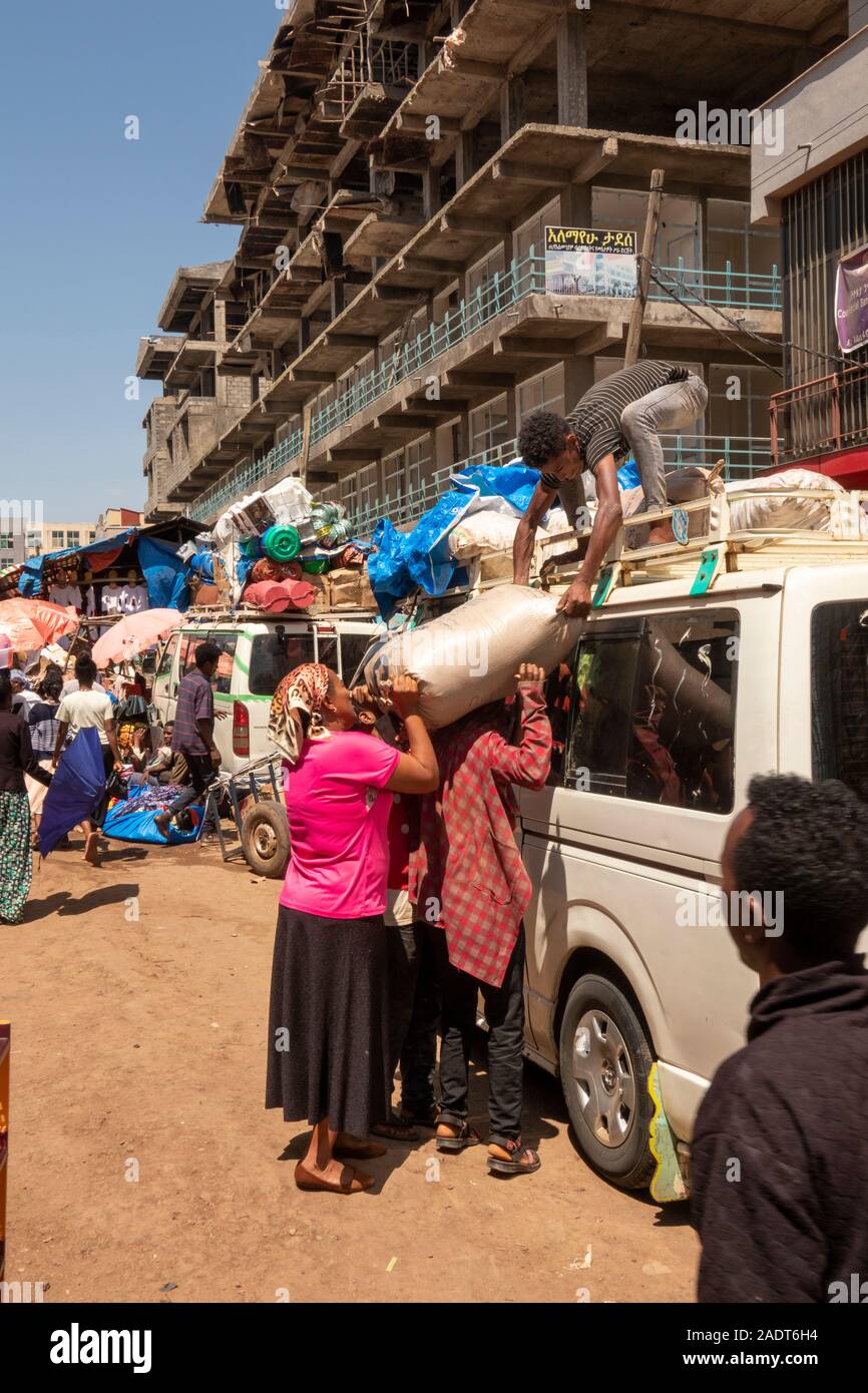 Ethiopia, Amhara Region, Bahir Dar, city centre, market, unloading sack from minibus roof Stock Photo