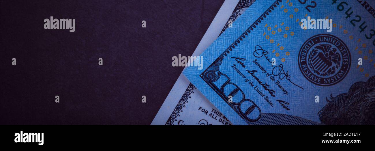 One hundred dollar bills on a gray background Stock Photo - Alamy