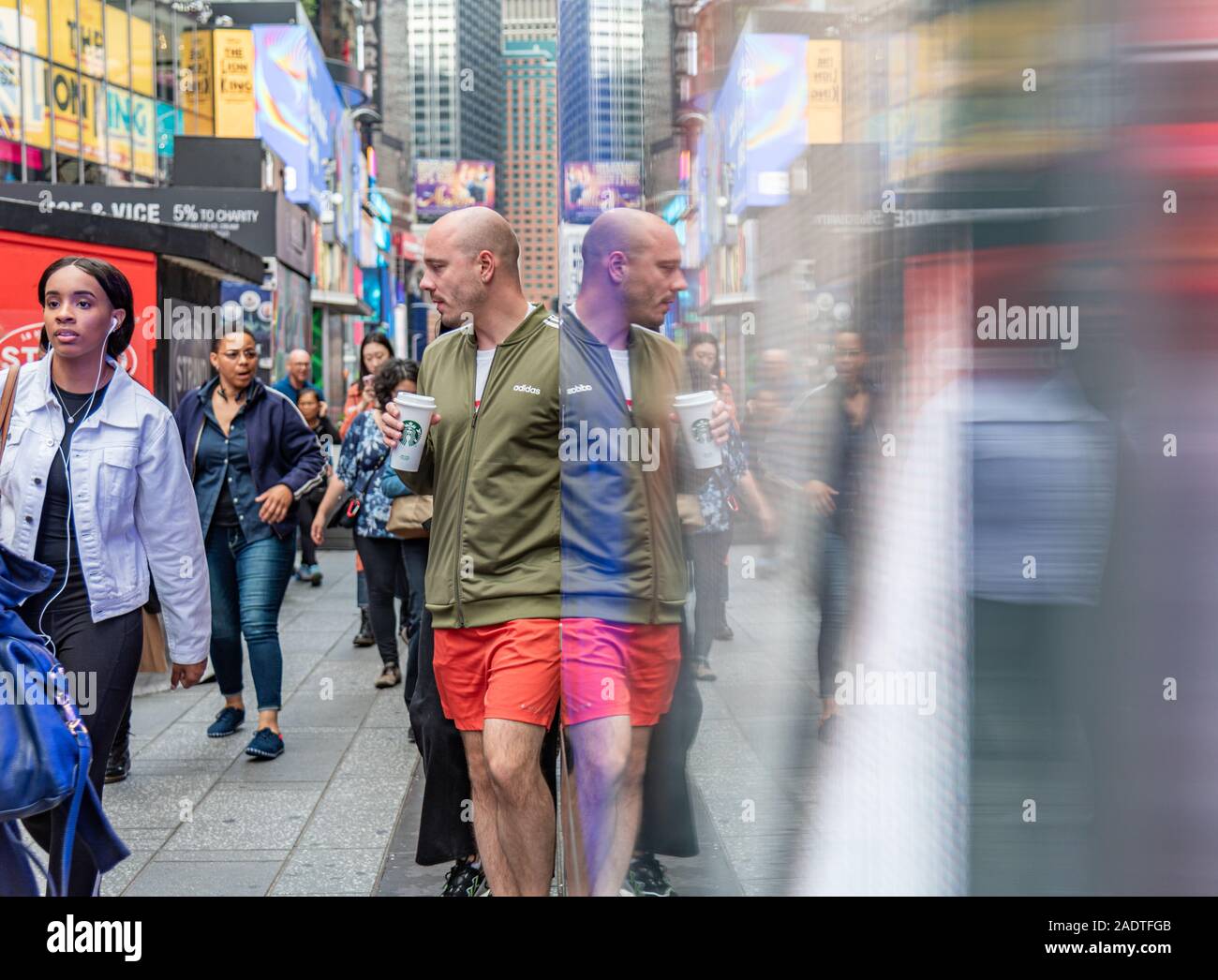 Manhattan New York color image mirror picture - Mirror image of people in time square Stock Photo