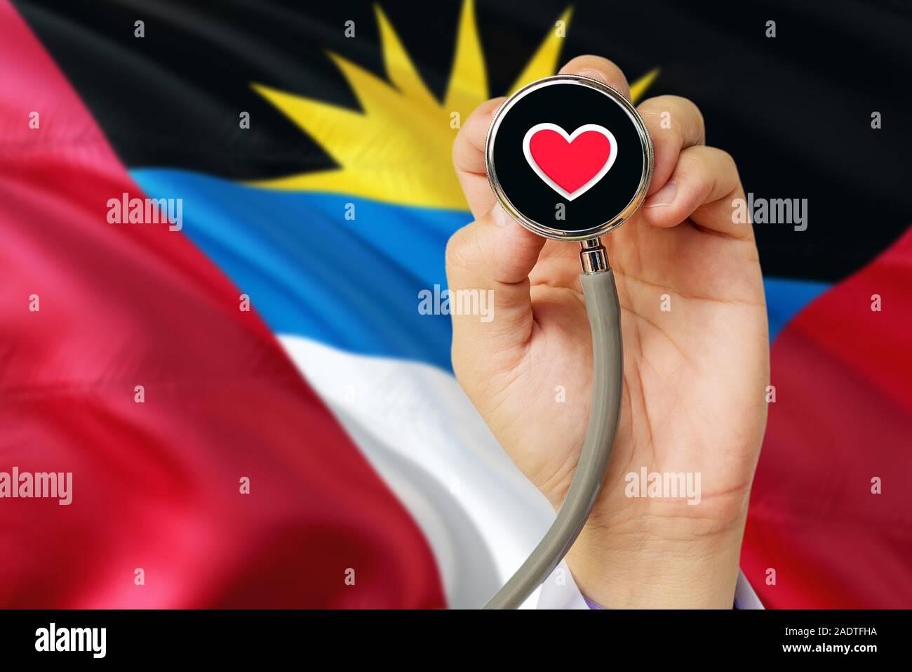 Doctor holding stethoscope with red love heart. National Antigua and